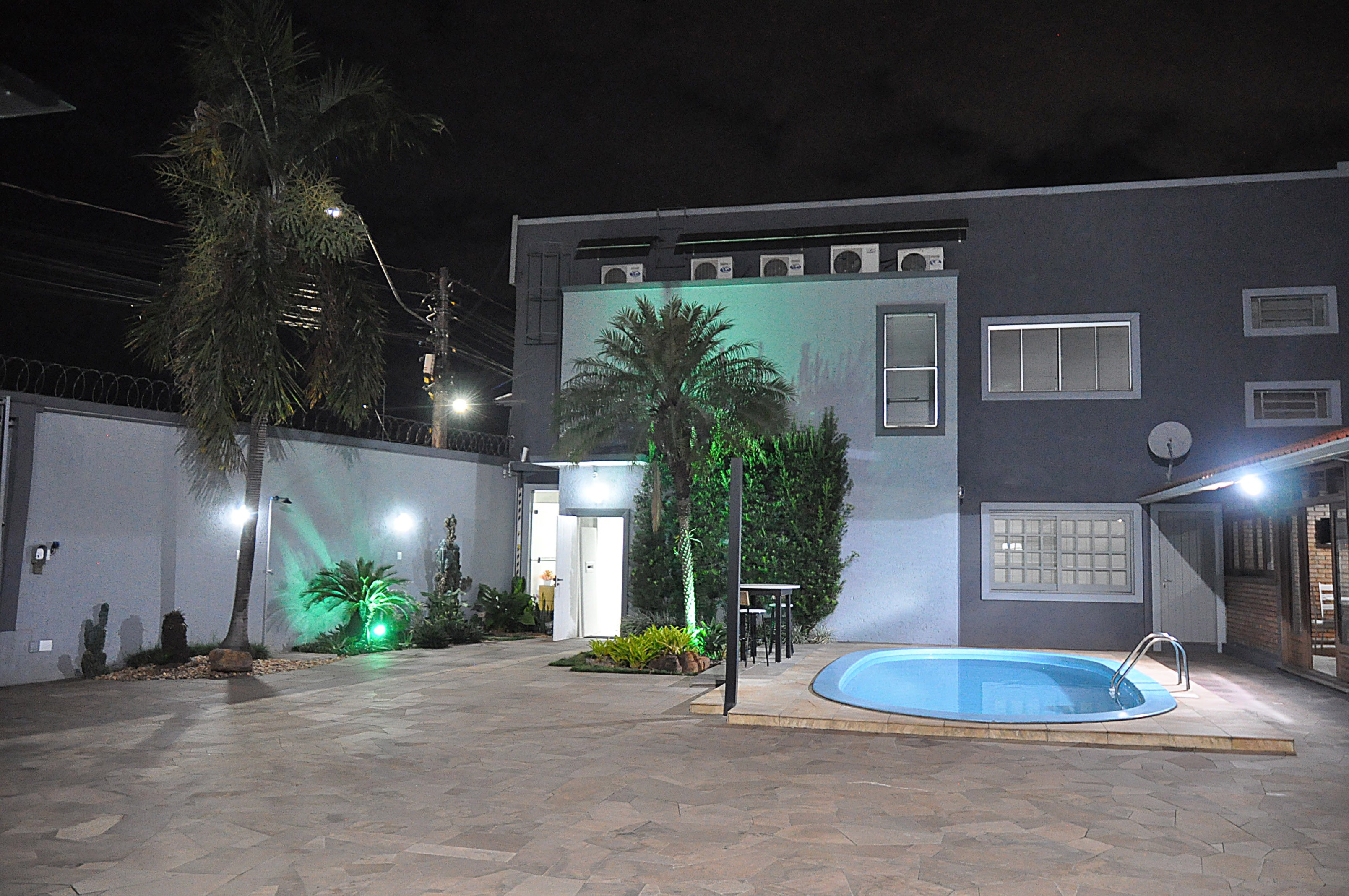 Área externa com piscina à noite