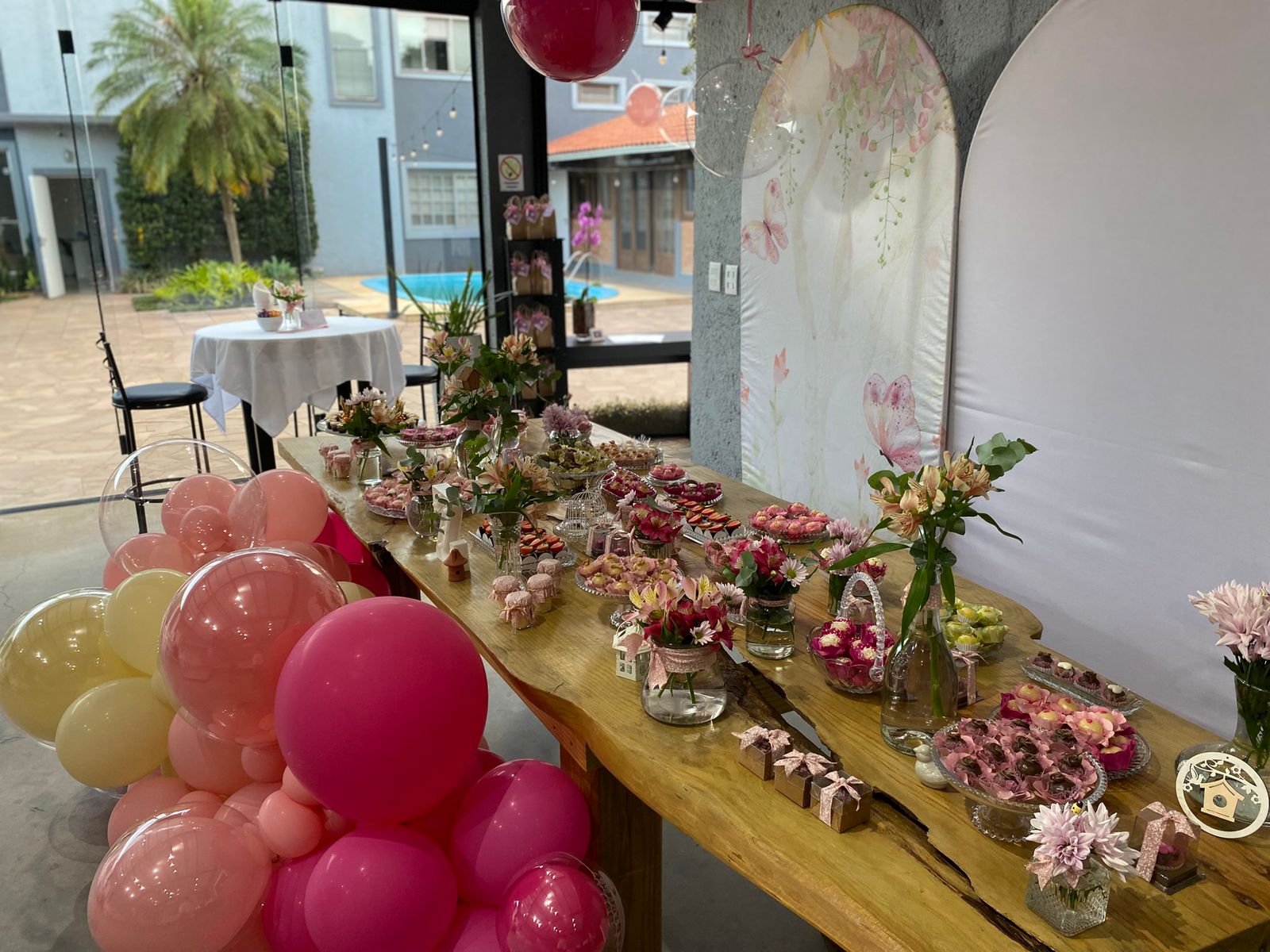 Mesa de doces com painel e arco de balões